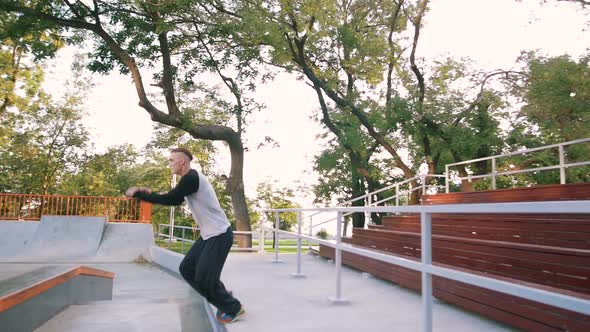 Young Man Doing Parkour Tricks in Extreme Sports Park