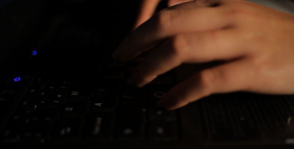 Female Hands Typing on Laptop (low key)