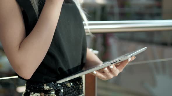 Young Female Passenger at the Airport Using Her Tablet Computer While Waiting for Flight Beautiful