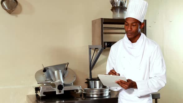 Chef writing on a clipboard