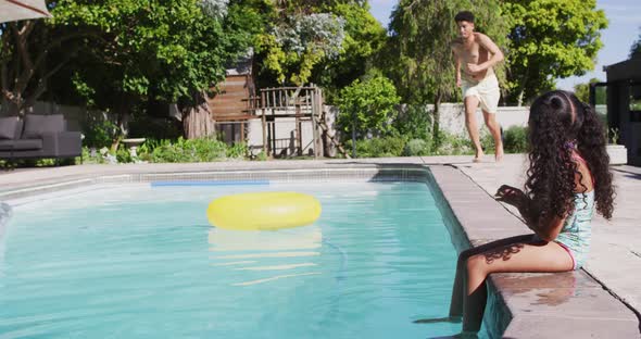 Happy biracial father and daughter spending time at pool together