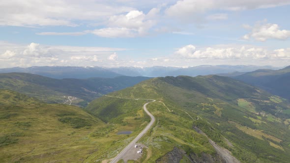 Beautiful aerial shot flying over a mountain range and valley in Norway