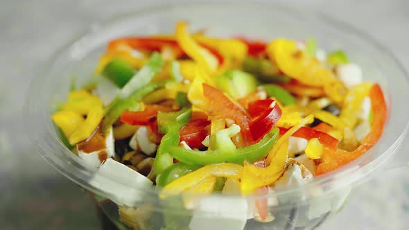 Close Up Slow Motion Video Shot of Fresh Greek Salad in Plastic Package for Take Away