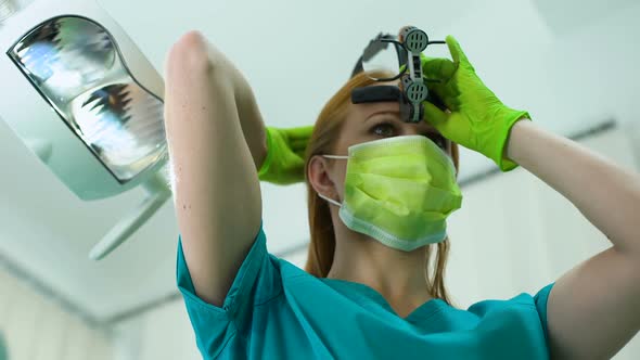 Female Dentist Wearing Magnifying Glasses With Light, Professional Equipment