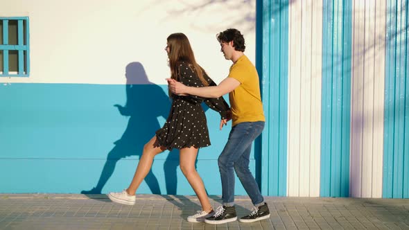 Couple dancing near building in city