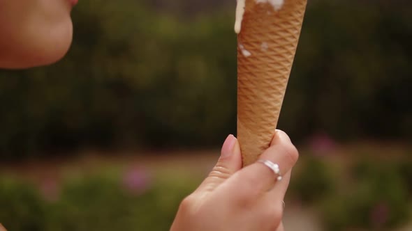 Close Up Footage Brunette Sensual Girl Licking Ice Cream on a Cone  White and Yellow Scoops