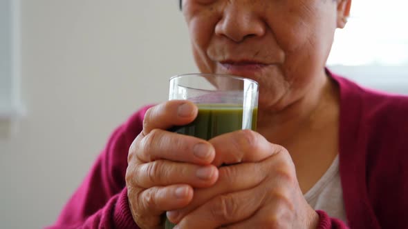 Senior woman having juice