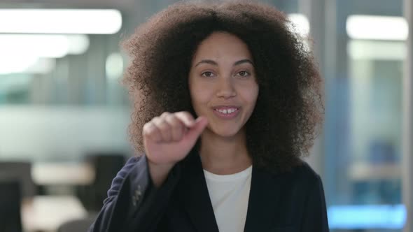 Portrait of African Businesswoman Pointing at the Camera and Inviting