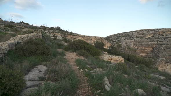 Path Leading to the Top of Blue Grotto Hill with Fence Made From Stones