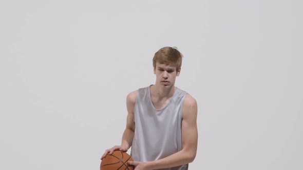 Portrait of Young Basketball Player Throwing the Ball Towards the Camera