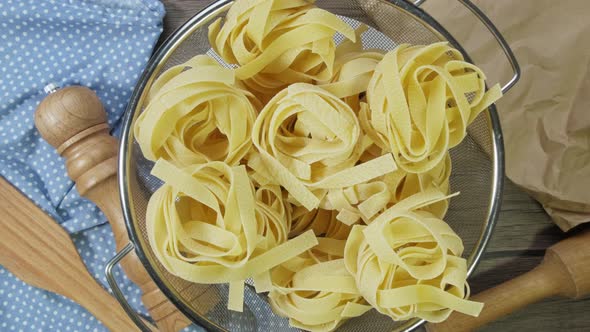 Close Up of Raw Pasta Rotate on Board. Fettuccine, Tagliatelle Pasta. Italian Cuisine. Food