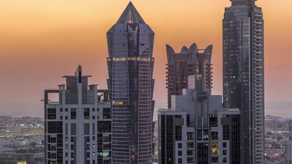 View of Illuminated Skyscrapers with Lights From Windows in Dubai at Sunset Aerial Timelapse