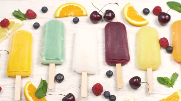 multicolored icicle with fresh fruit on white background