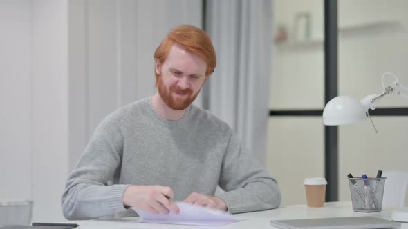 Beard Redhead Man Unable to Write on Paper at Work