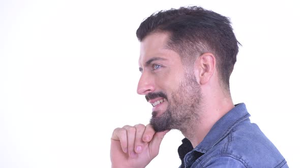 Closeup Profile View of Happy Young Bearded Hipster Man Thinking