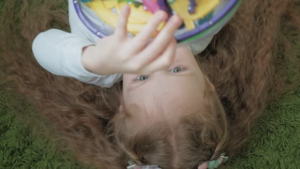 Little Girl Play with Threedimensional Toy Puzzle