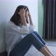 Women sitting on the wall in the room alone, show stress from life problems. - VideoHive Item for Sale