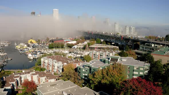 Aerial rise over Granville Island, Vancouver on a foggy morning