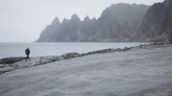 Hiker Walking Rocks Near Fjord