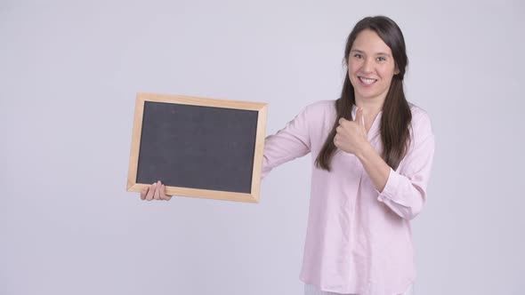 Young Happy Businesswoman Holding Blackboard and Giving Thumbs Up