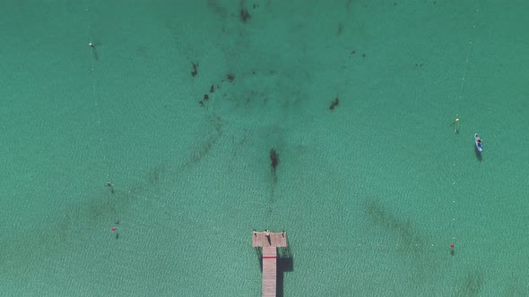 Couple standing on pier at sunset