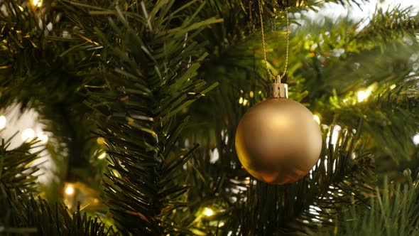 Gold color bauble on the tree 4K 2160p 30fps UltraHD footage - Golden Christmas ornament close-up 38