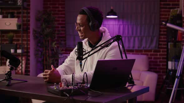 Closeup of Podcast Presenter Reading Questions From Audience Using Laptop to Woman Content Creator