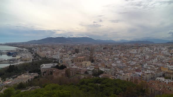 High above Panorama view over Malaga City with mountains on cloudy day