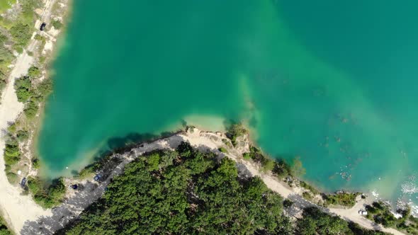 Aerial View of a Blue Lake Surrounded By Forest