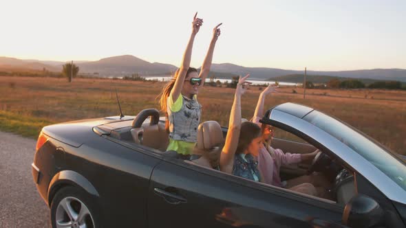 Cheerful Girls Having a Fun in a Convertible Car