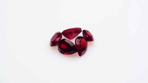 Natural Red Garnet Gemstone on the White Background on the Turning Table