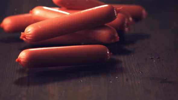 Super Slow Motion Sausages Roll on the Table