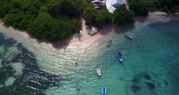 Wide angle overhead abstract view of a white paradise beach and aqua blue water background in vibran