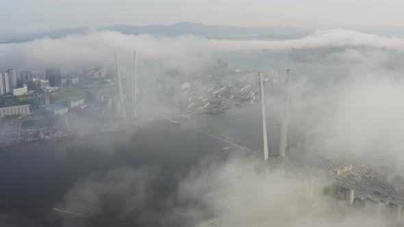 Drone View of the Golden Bridge in the Fog and the City at Sunset