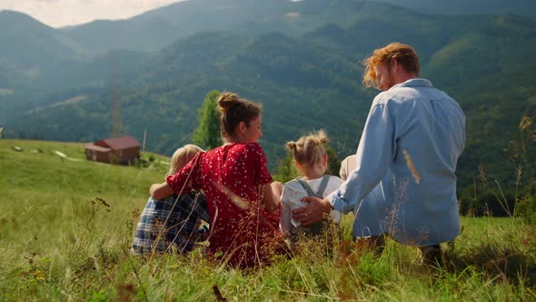 Parents Sitting Grass Mountains Hill with Children