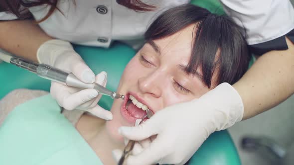 Dentist at work in the office. Woman dentist working at her patients teeth