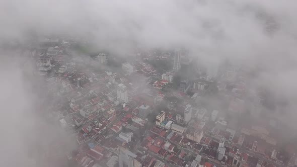 Aerial look down foggy cloud of city.