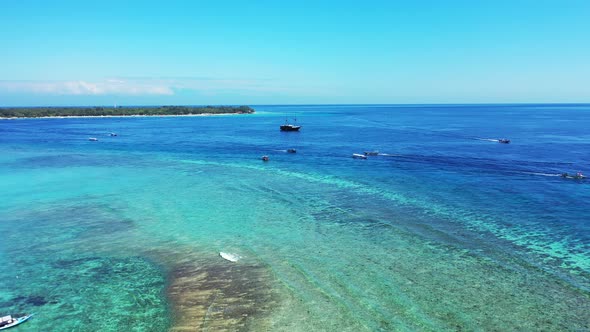 Vivid colors of seascape with shallow calm water of turquoise lagoon surrounded by coral reef border