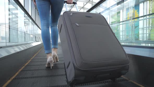 Legs of Business Woman Going Through Hall of Terminal with Her Luggage. Young Girl in High Heels