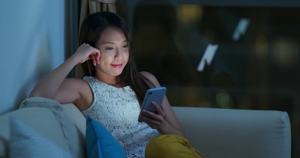 Woman look at mobile phone at night