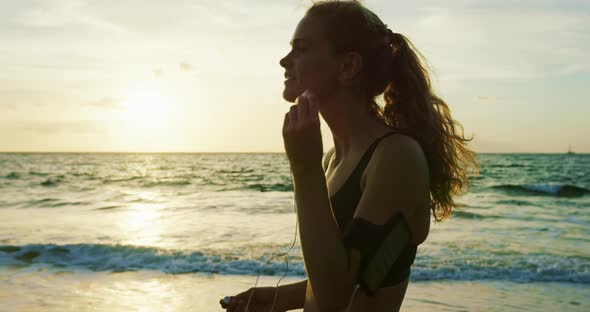 Athletic Young Woman Running at Sunset