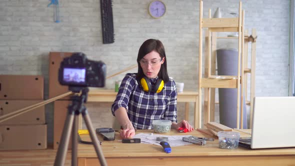 Young Woman DIY Blogger Recording Video in Garage Workshop