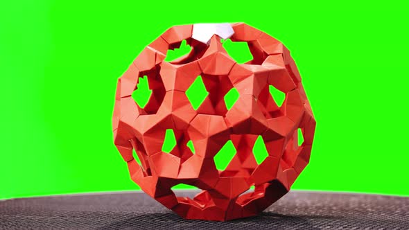 Red Modular Origami Ball on Green Screen.