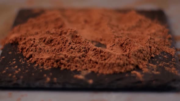 Rolling chocolate truffle in cocoa powder