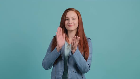 Applauding Young Pretty Woman, Clapping on Turquoise Background