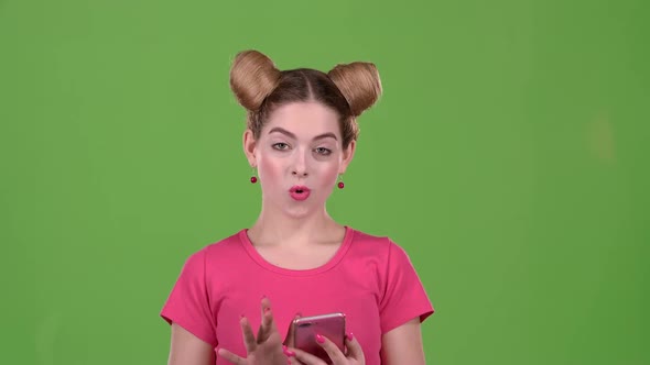 Teen Advertises the Phone and Shows a Thumbs Up. Green Screen. Slow Motion