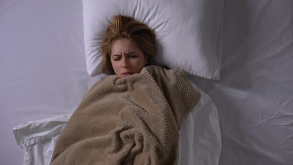 Woman Covering With Blanket Lying in Bed, Feeling Fever, Symptoms of Cold