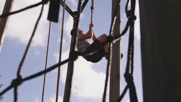 Young man training at an outdoor gym bootcamp