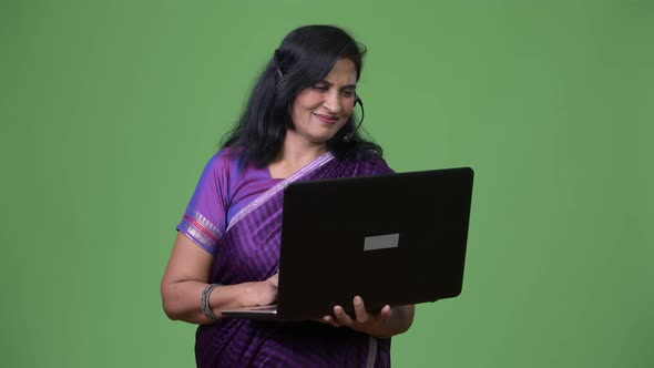 Mature Happy Beautiful Indian Woman As Call Center Representative Using Laptop