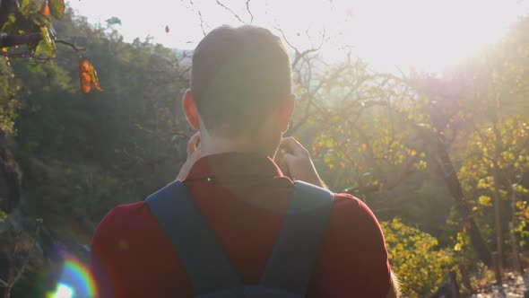 Young Tourist Man with Backpack in Nature Landscape Shooting Photo or Video on Mobile Phone